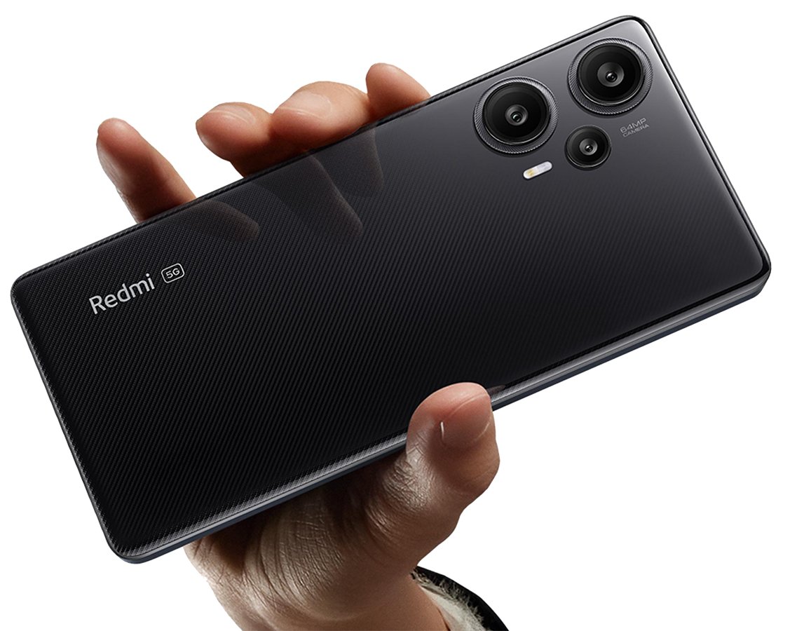  A hand holding a black Xiaomi Redmi Turbo 3 smartphone, which has three rear cameras and a flash.
